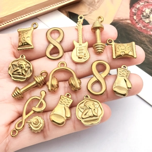 Golden stainless steel DIY charms featuring guitar, dumbbell, and angel designs for jewelry