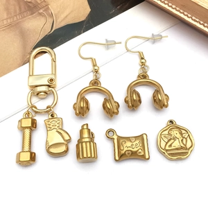 Golden stainless steel jewelry set featuring angel pendant, dumbbell, and boxing glove charms