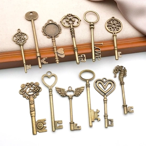 Detail of 11 vintage bronze alloy key pendants with heart and steampunk designs for DIY jewelry