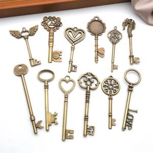 Macro shot of 12 assorted vintage bronze key charms on white satin for jewelry DIY projects