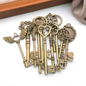 Detailed view of assorted antique bronze DIY key pendants with LOVE and heart engravings