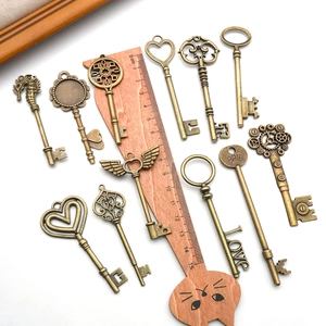 Set of 11 vintage bronze alloy key pendants with heart and crown designs for DIY jewelry