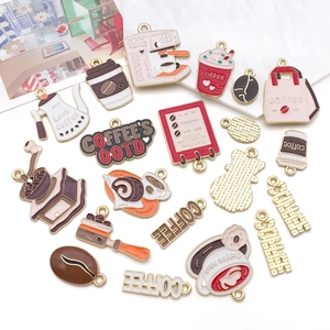 Detailed macro view of assorted coffee-themed zinc alloy enamel pendants for DIY jewelry