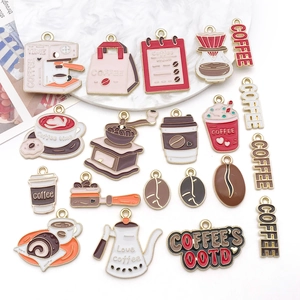 Detailed close-up of DIY enamel coffee charms featuring grinders and cups in gold plating