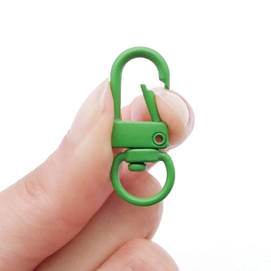 Detail view of a grass green alloy lobster clasp with a rotating ring for DIY keychains