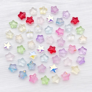 Macro shot of colorful star-shaped glass beads with gold foil and aurora finish