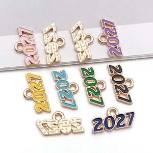 Vue macro de breloques année 2027 en émail coloré avec cadres en alliage doré pour bijoux