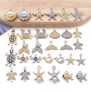 Macro shot of gold and silver sea animal pendants with rhinestones and pearls