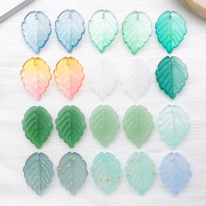 Detailed view of frosted leaf pendants in various colors for DIY jewelry making