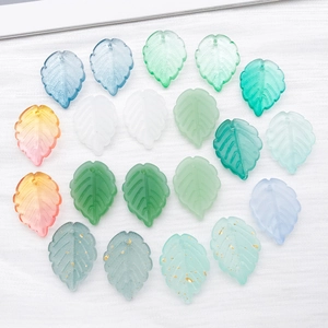 Detailed view of frosted glass strawberry leaves with gold foil for DIY necklace jewelry