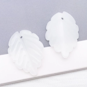 Macro detail of white frosted leaf pendant with clear veins and pre-drilled DIY hole