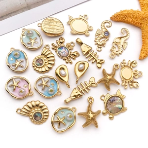 Golden sea life charms with shell and pearl accents for DIY jewelry making