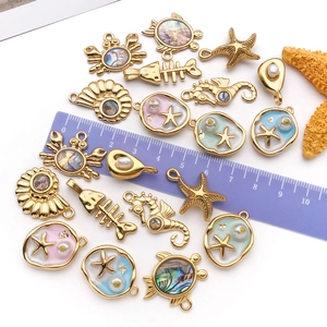Detailed set of gold plated ocean pendants including crabs and sea stars for DIY jewelry