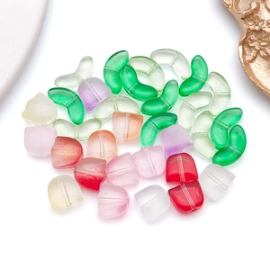 Detailed view of matte frosted glass beads in tulip and leaf shapes for DIY jewelry making