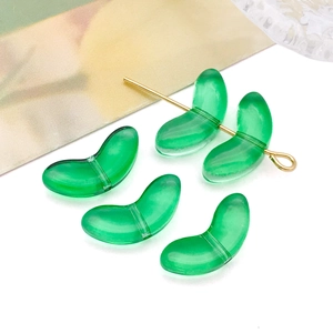 Macro shot of green translucent tulip bud beads with golden pins for DIY jewelry