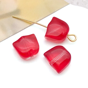 Macro view of gradient red glass tulip flower beads for DIY jewelry making
