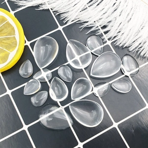 Close-up of teardrop transparent glass cabochons for DIY jewelry and crafts