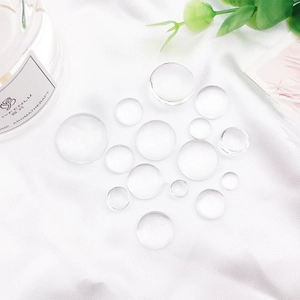 Macro shot of clear dome glass cabochons for DIY jewelry and badge making projects