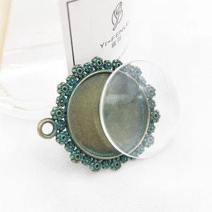 Macro shot of antique bronze bezel with floral relief and clear glass cabochon insert