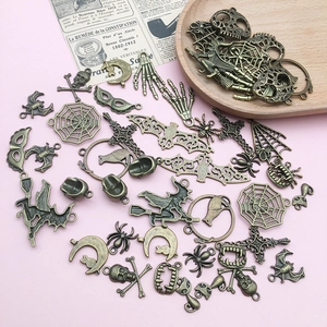 Close-up of bronze Halloween charms including skulls, bats and spider webs for DIY jewelry