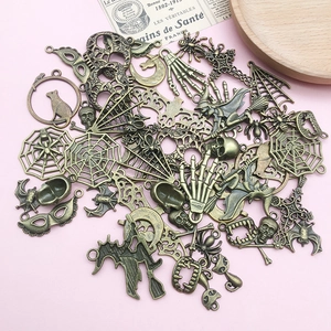 Detailed macro view of assorted vintage bronze Halloween alloy pendants on a wooden tray