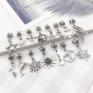 Detailed macro view of antique silver charms with star and crown shapes for DIY jewelry