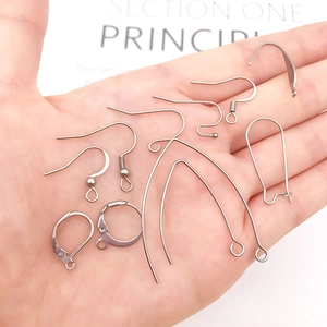 Hand holding assorted stainless steel earring hooks and DIY jewelry making components