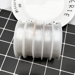 Macro detail of four rolls of transparent elastic crystal cord for DIY jewelry beading