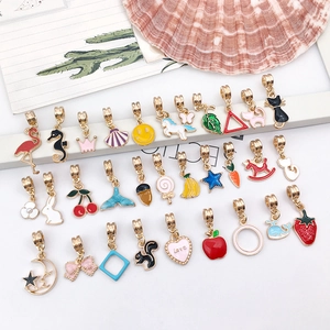 Flat lay of colorful enamel crown and heart charms for DIY jewelry making accessories