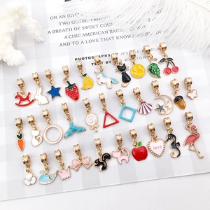 Collection of colorful enamel pendants featuring crown, heart and unicorn motifs