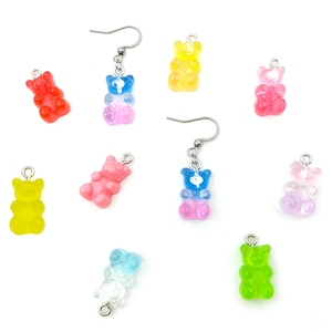 Detailed view of colorful resin gummy bear pendants and earrings in various vibrant colors