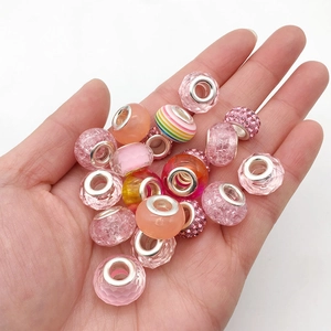 Macro shot of assorted pink glass and resin large hole beads for DIY jewelry making