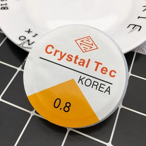 Close-up of 0.8mm Crystal Tec elastic bead cord on a ceramic plate for DIY jewelry