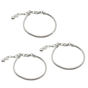 Detailed view of silver snake chains with heart pendants and lobster clasps