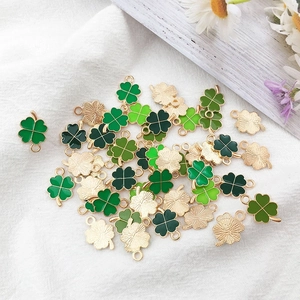 Macro shot of green enamel four leaf clover pendants for DIY jewelry crafting