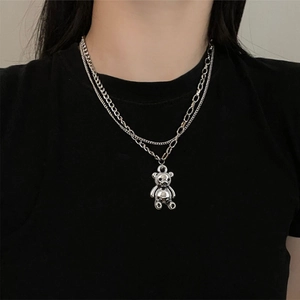 Double-layered silver chain necklace with a cute 3D teddy bear pendant on black shirt
