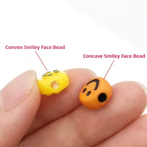 Macro detail of yellow convex and orange concave smiley face acrylic beads for DIY jewelry