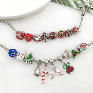 Detailed close-up of Christmas charm bracelet with snowflake and Santa Claus pendants