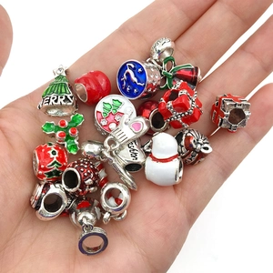 Macro view of Christmas charms like reindeer and snowmen held in hand for size