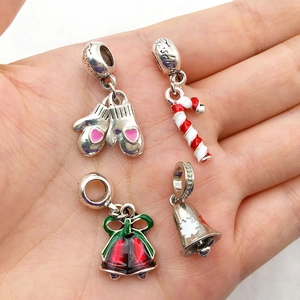 Detailed macro of Christmas DIY charm beads with enamel finish and Fashion engraving