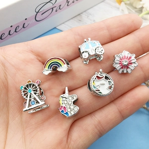 Detail of silver alloy beads set featuring rainbow, unicorn and wheel for DIY bracelets
