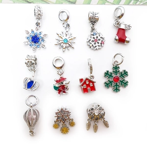 Detail view of colorful Christmas enamel pendants including snowflakes and Santa Claus charms