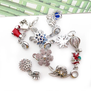 Detailed view of assorted Christmas-themed silver charms with colorful enamel and crystals