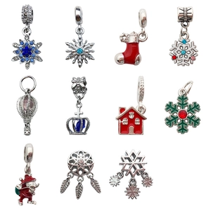 Variety of festive Christmas charms including snowflakes, stockings, and silver pendants
