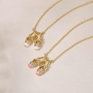Collana con ciondolo scarpette da ballo in oro con zirconi lucenti ed elegante