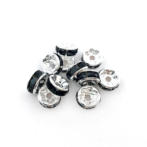Detailed macro view of 10 silver plated spacer beads with black rhinestones for DIY jewelry