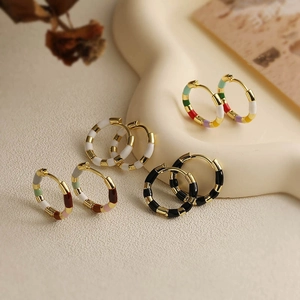 Detail view of French retro U-shaped enamel hoop earrings in assorted vintage colors