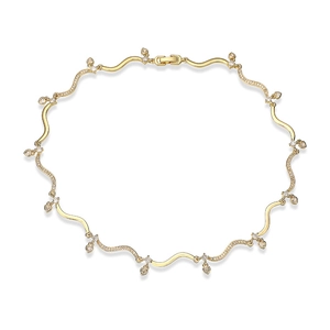 Macro shot of gold-plated wave chain necklace with heart charms and sparkling zircons