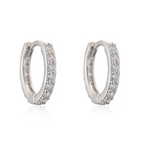 Macro view of silver huggie hoop earrings with micro-pave round cubic zirconia stones