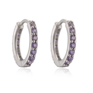 Macro view of silver huggie hoop earrings featuring inlaid purple round gemstones